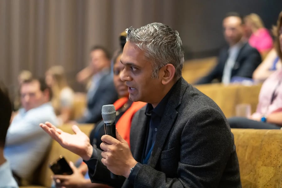 Man with a microphone asking a question.